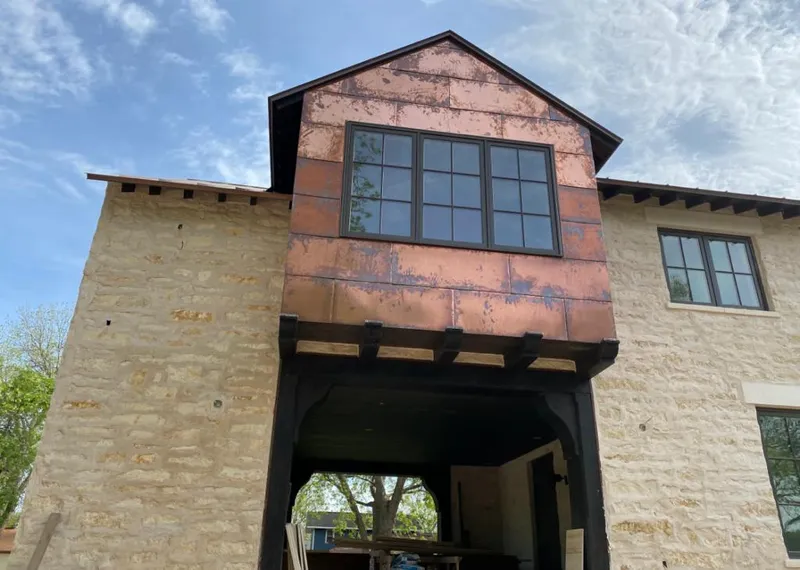 Copper metal panel facade on a stone building for Metal Roof Coating in Kingsport